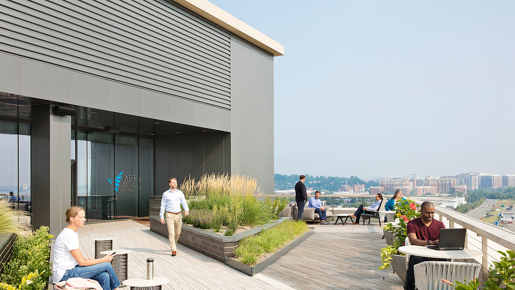 A group of people sitting outside a building.