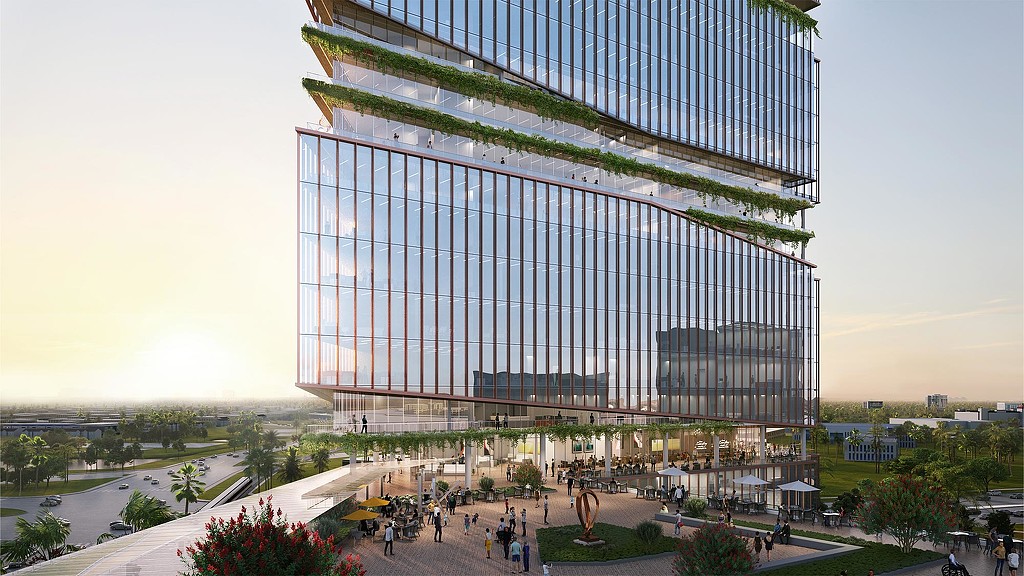 A large glass building with people walking around.