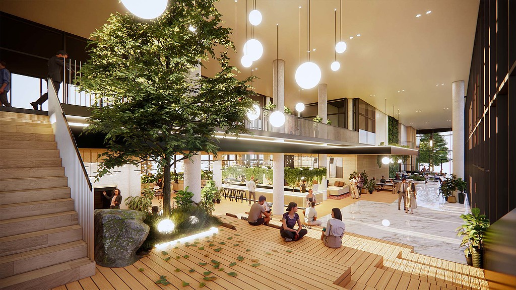 A group of people sitting on the floor of a building.