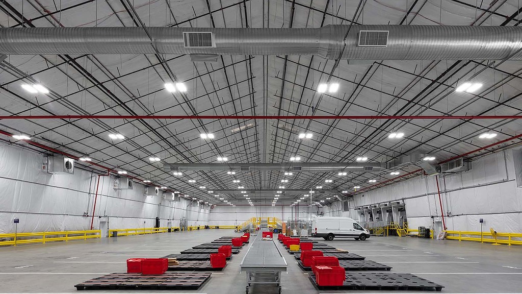 A large warehouse with several red and white boxes.