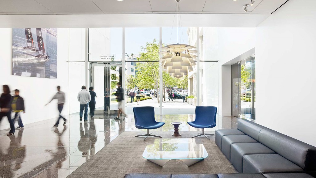 A large room with a couch and chairs.