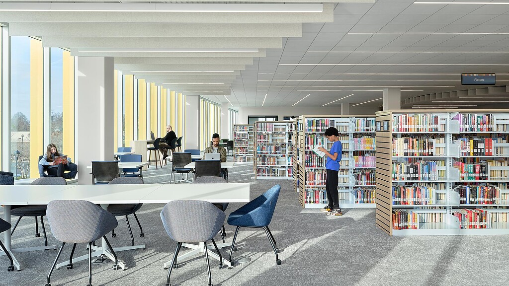 A person standing in a library.