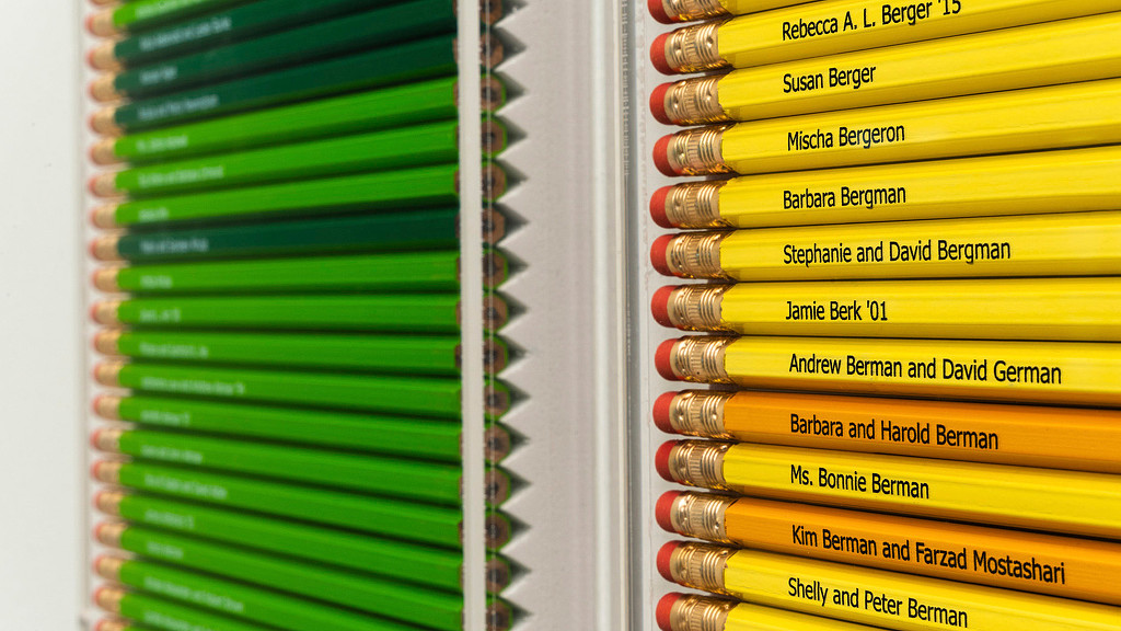 Close-up of yellow and green pencils with Georgetown Day School alumni names