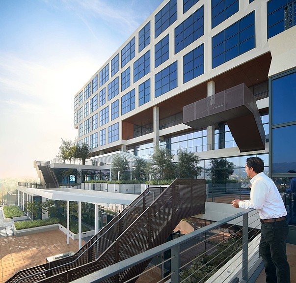 A man looking out from Epic building terrace