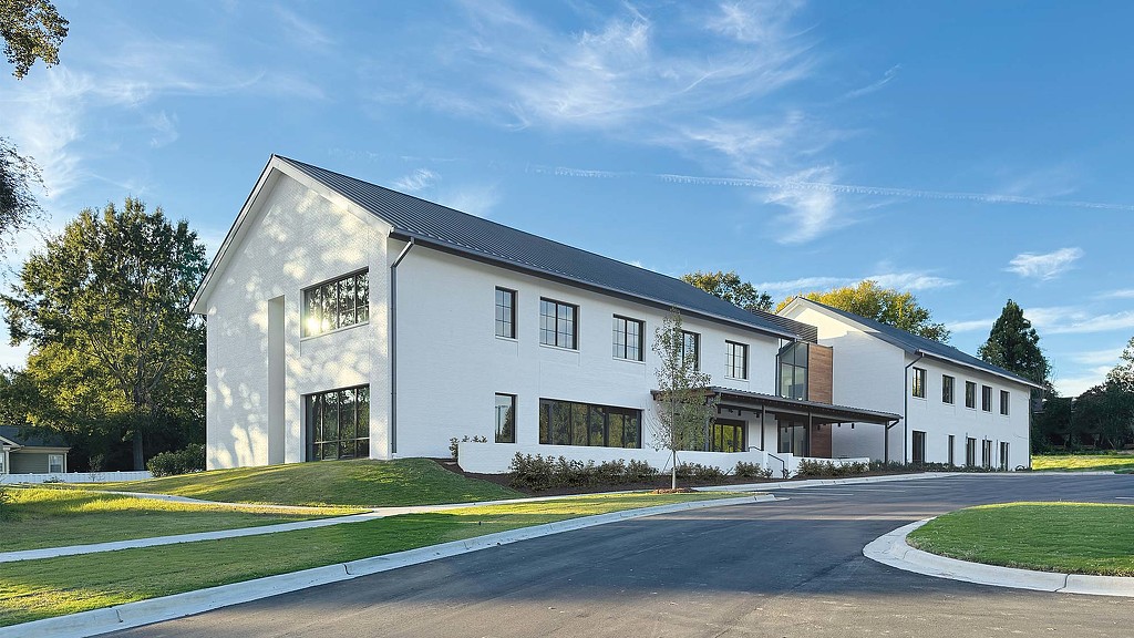 A white house with a driveway.