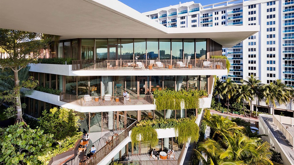 A building with a pool and trees.