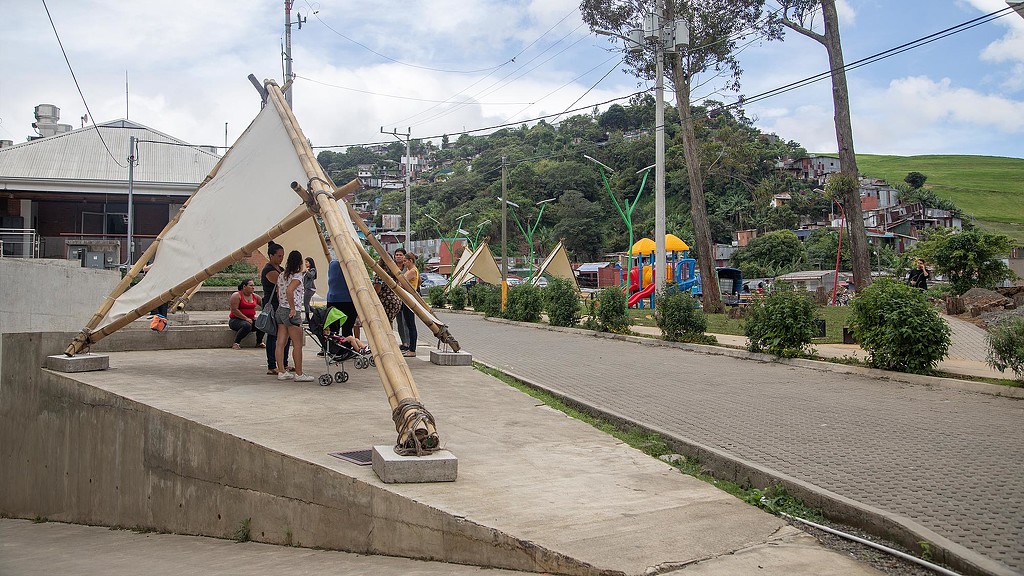 A group of people standing under a sustainable shade structure in Costa Rica