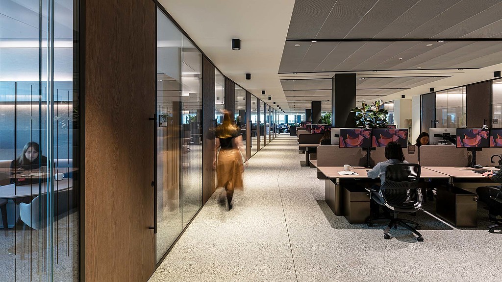 A person walking in an office.