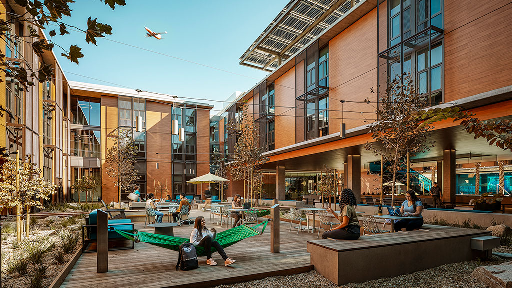 People sitting on a bench in front of a building.