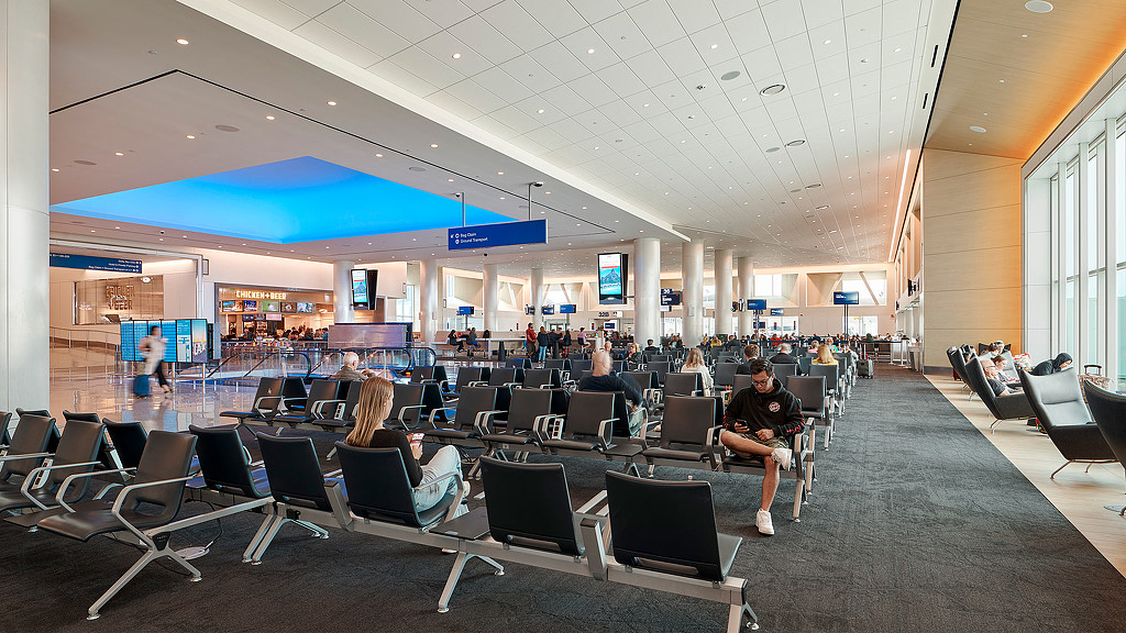 Passengers seated waiting at Delta Sky Way at LAX