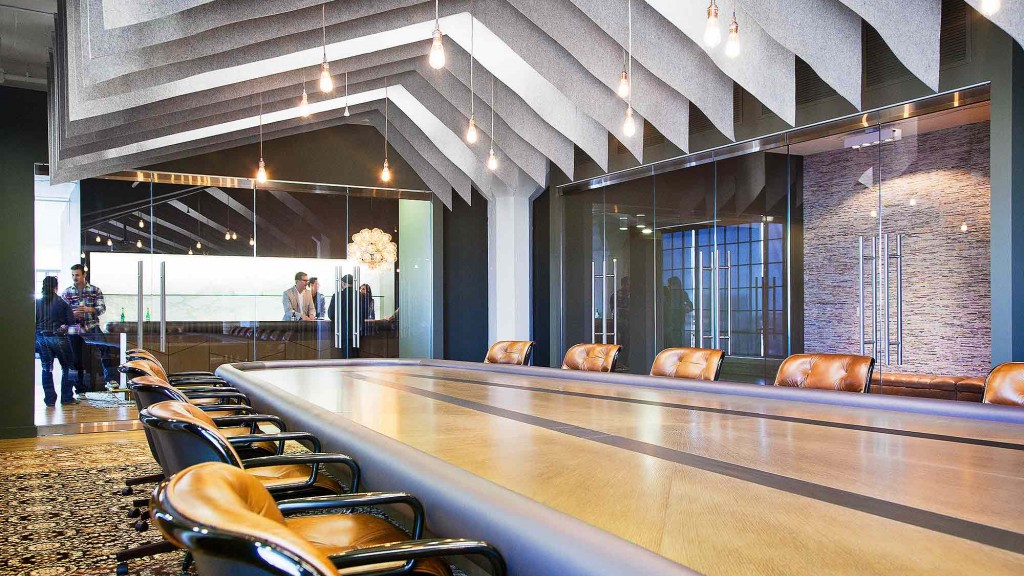 A large room with a bar and chairs.