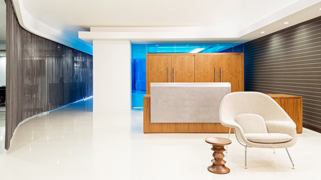 A room with a table chairs and a wood cabinet.