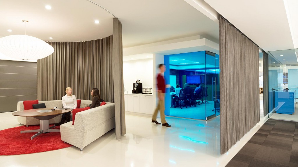 A man and a woman in a room with a glass door.