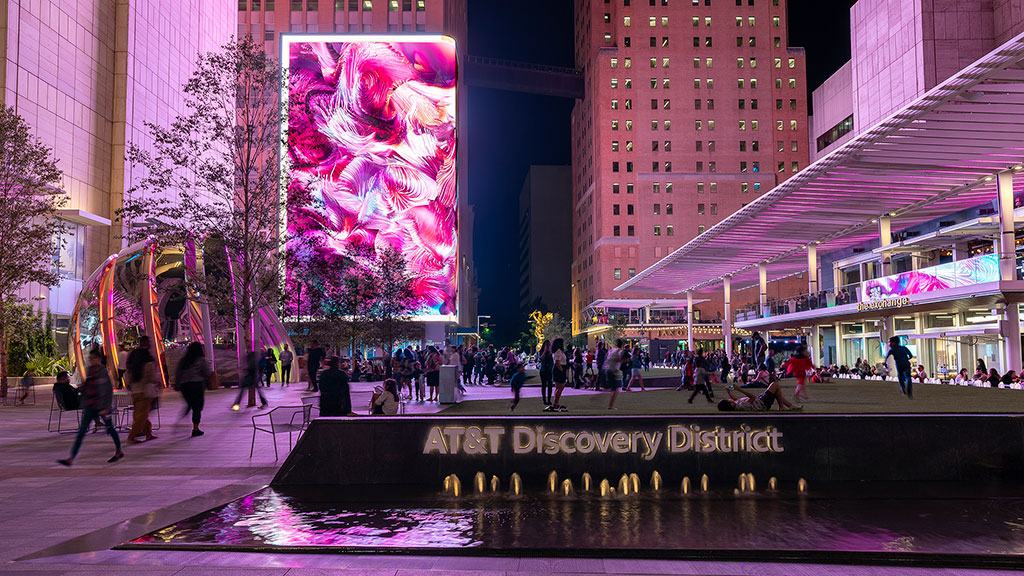 A group of people walking around a city.
