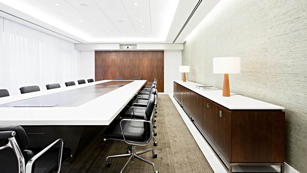 A room with a large table and chairs.