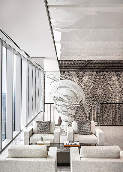 A room with a statue and a couch.