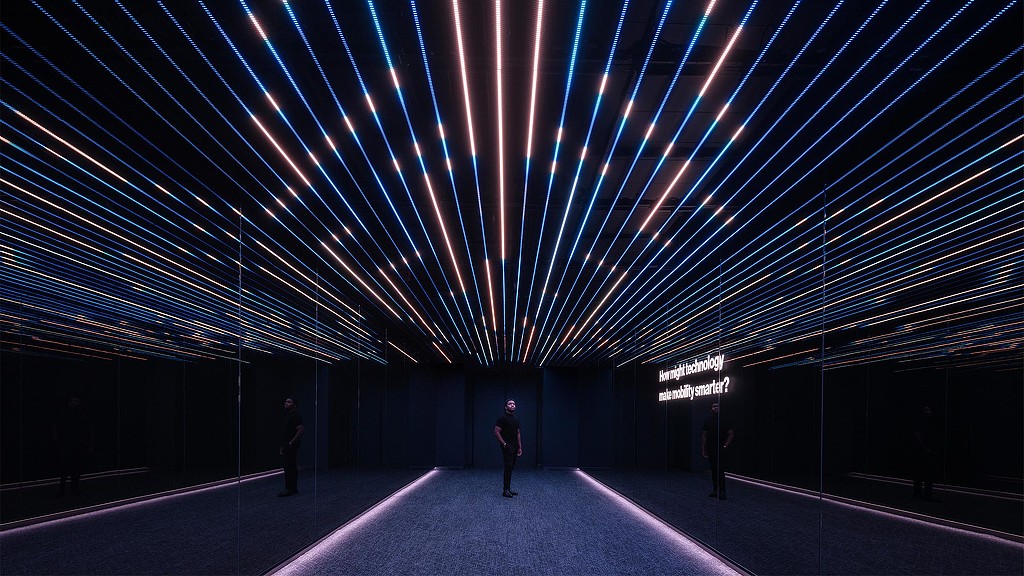 Man standing in the middle of Verizon Innovation Center, San Francisco room with immersive digital installation