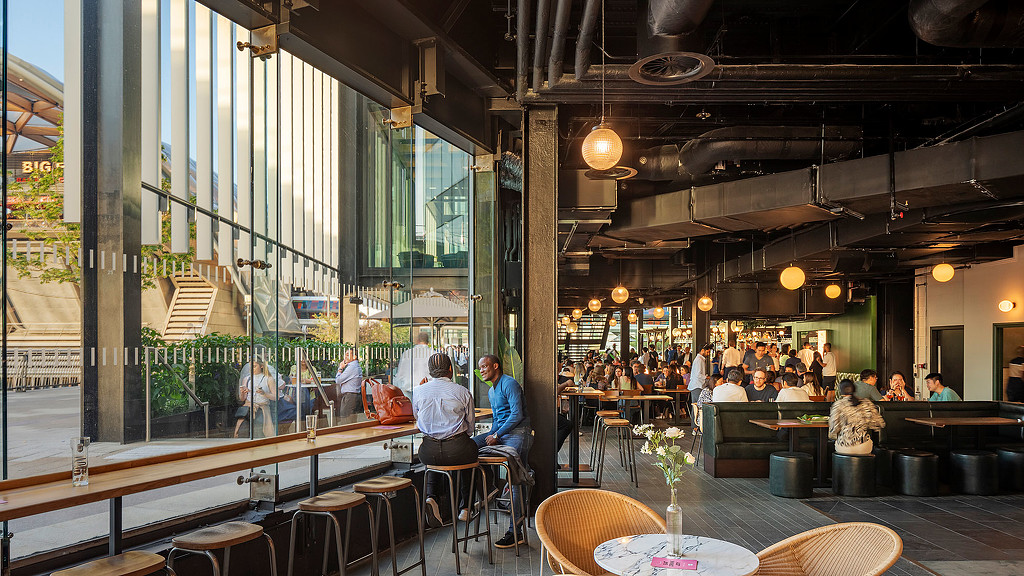 A group of people sitting at tables.