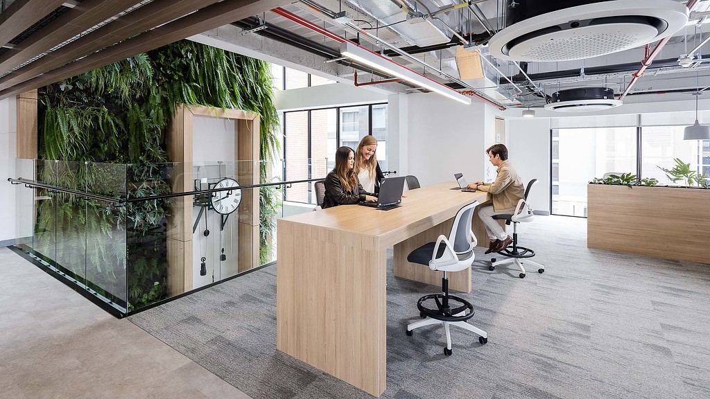 A few people working at a table.