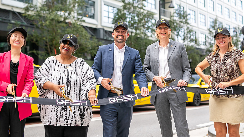 A group of people posing for DASH ribbon cutting