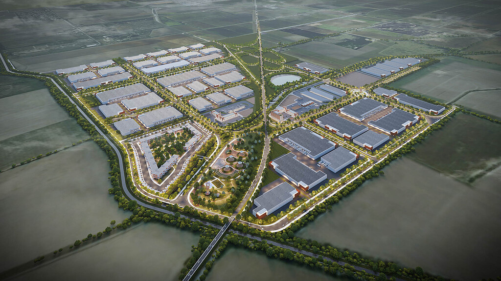 A large building with a green lawn.