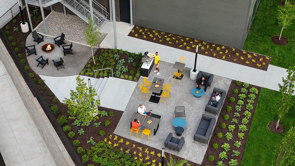 A group of people sitting around a table outside.