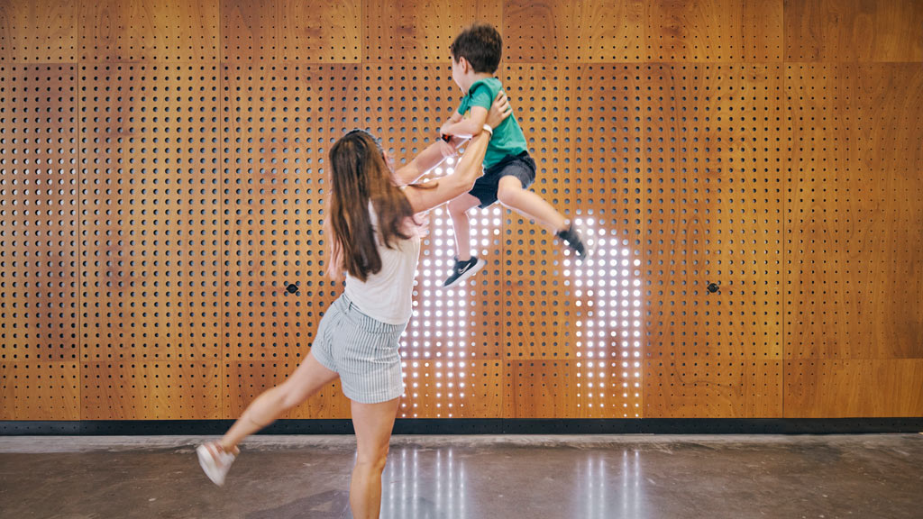 A person holding a child on the back.