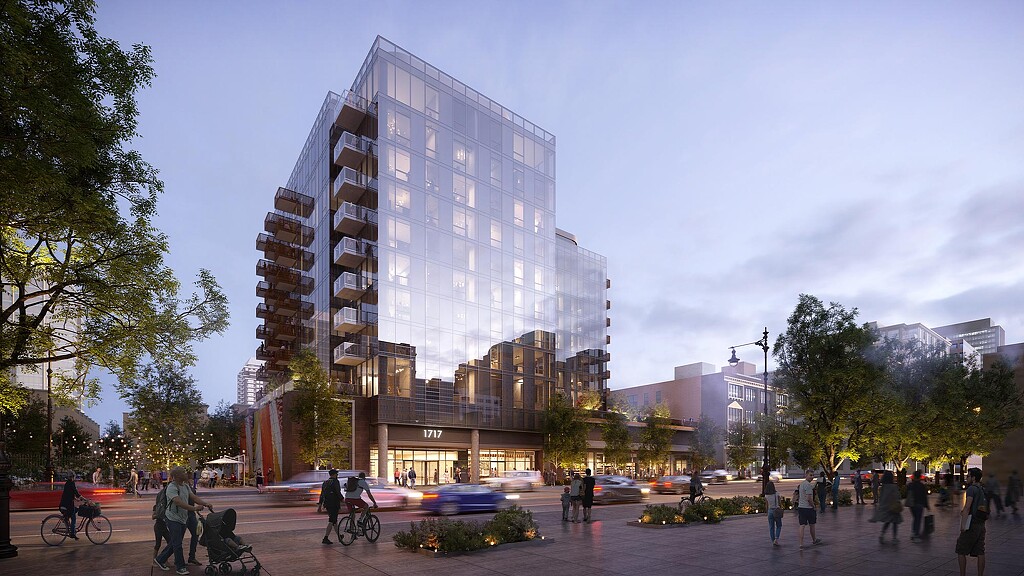 A large glass building with people walking around.