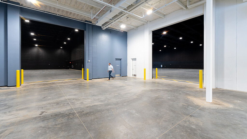 A person walking in a large empty building.