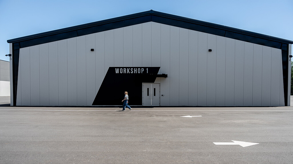 A man walking in front of a building.