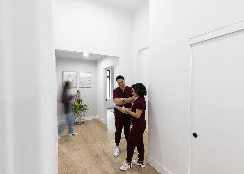 Two Open Wellness doctors conversing in hallway