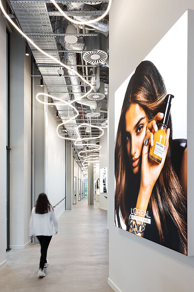 A woman walking down a hallway.