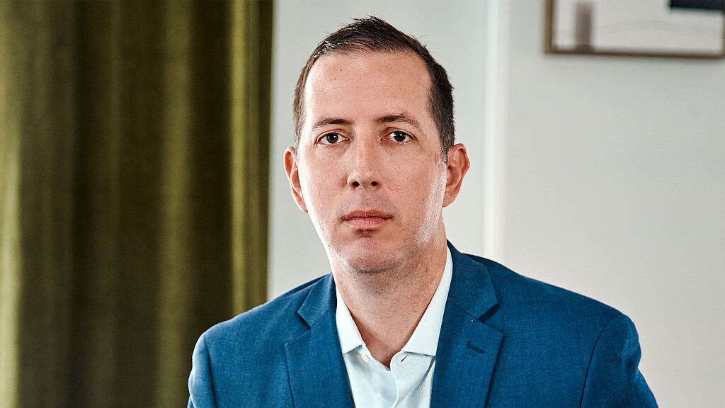 A man in a blue shirt.