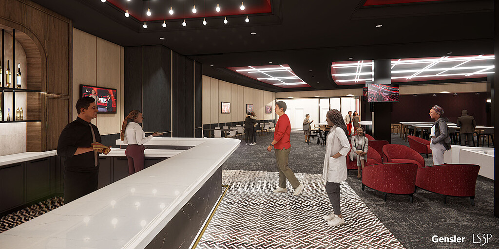 People in a room with chairs and a large display.