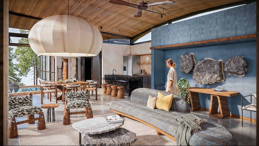 A person standing in a room with a large bed and a table.