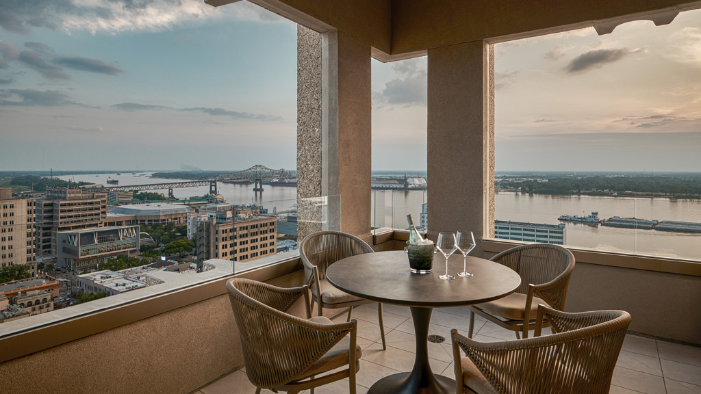 A table and chairs on a balcony.