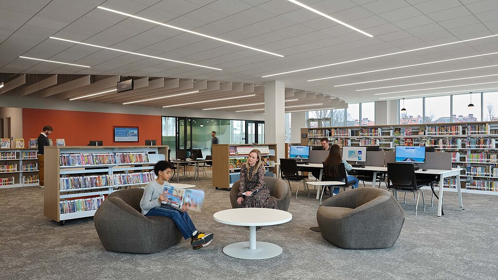 A group of people sitting in a library.