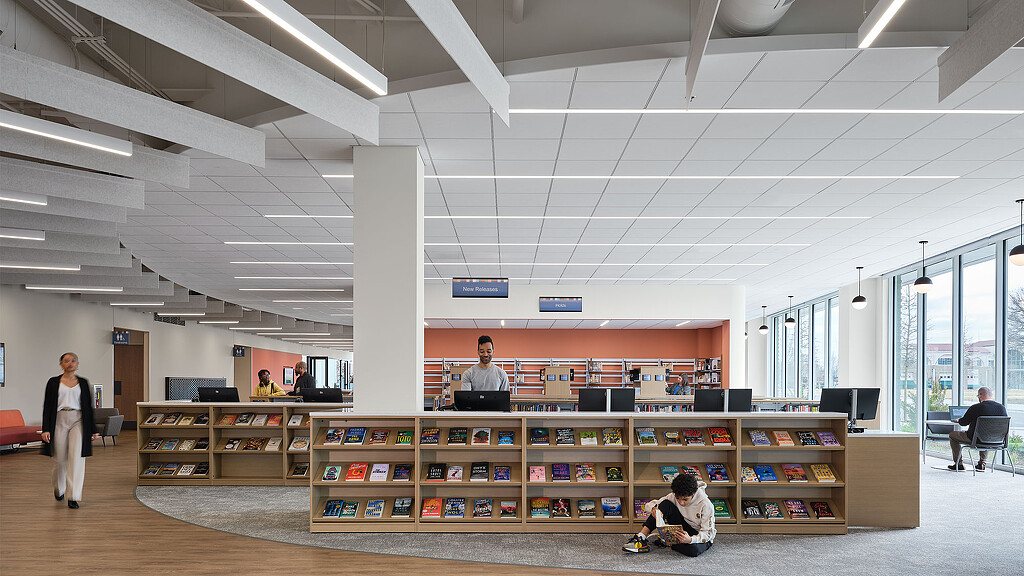 A few people in a library.