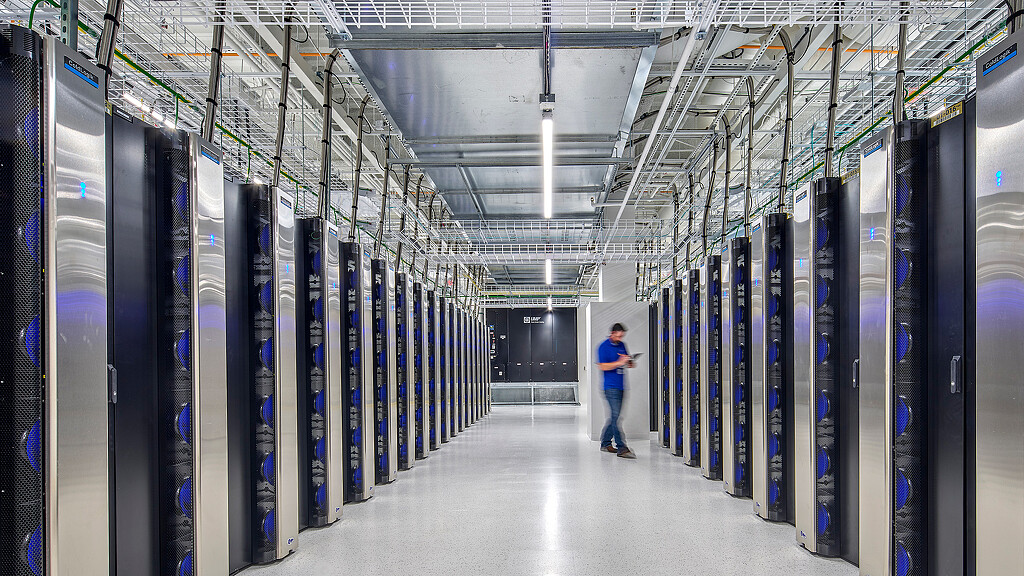 A person walking in a server room.