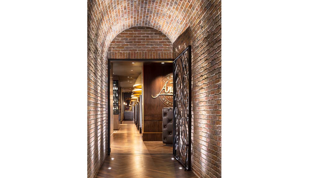 A hallway with a door and a sign on the wall.