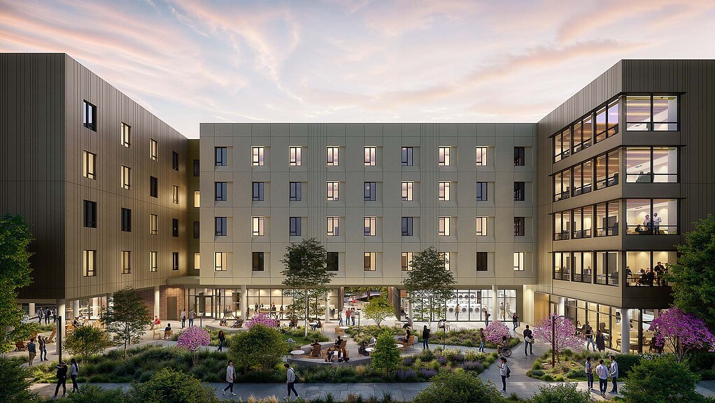 A group of people walking around a building.