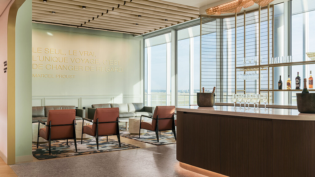 A room with a bar and chairs.
