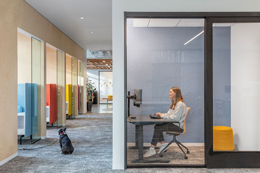 A person sitting at a table with a dog.