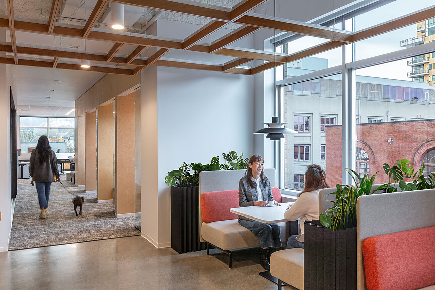 A group of people sitting in a room with a dog.