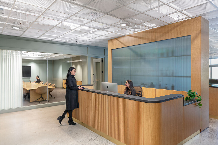 A person standing in front of a large screen.