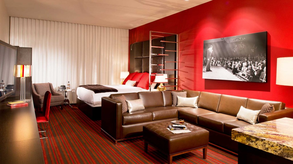 A living room with a large red wall.