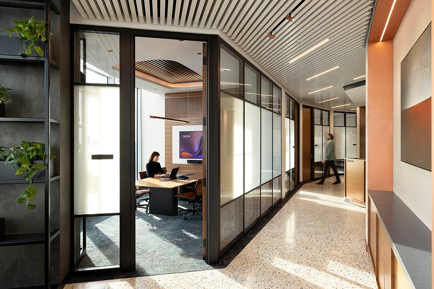 A person working on the laptop in an office.