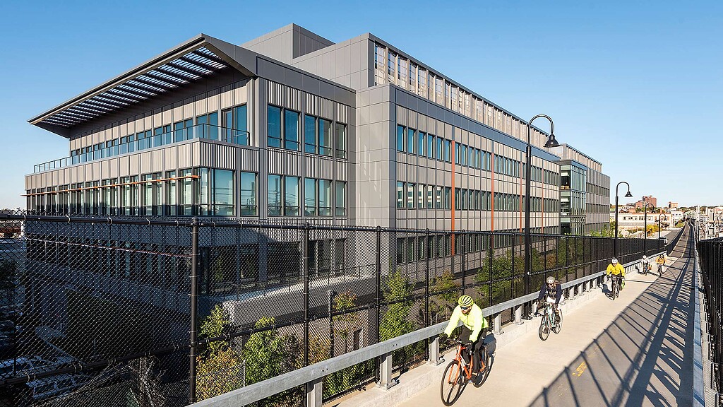 A group of people riding bikes on a bridge.