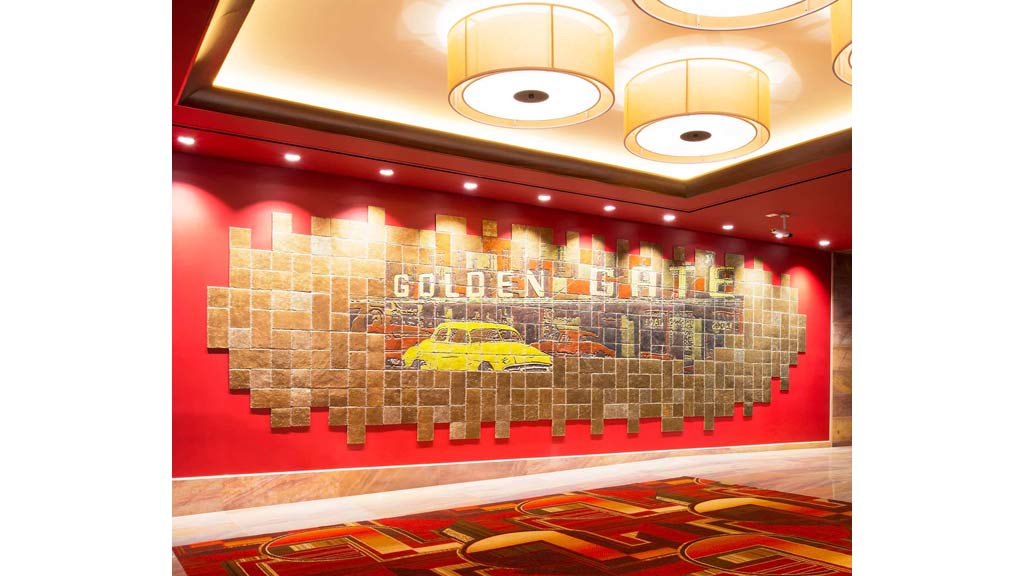 A room with a wall of pictures.