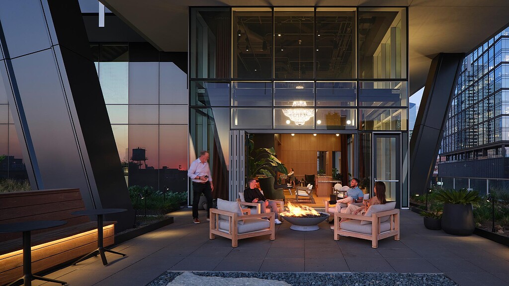 People sitting on benches in a building.